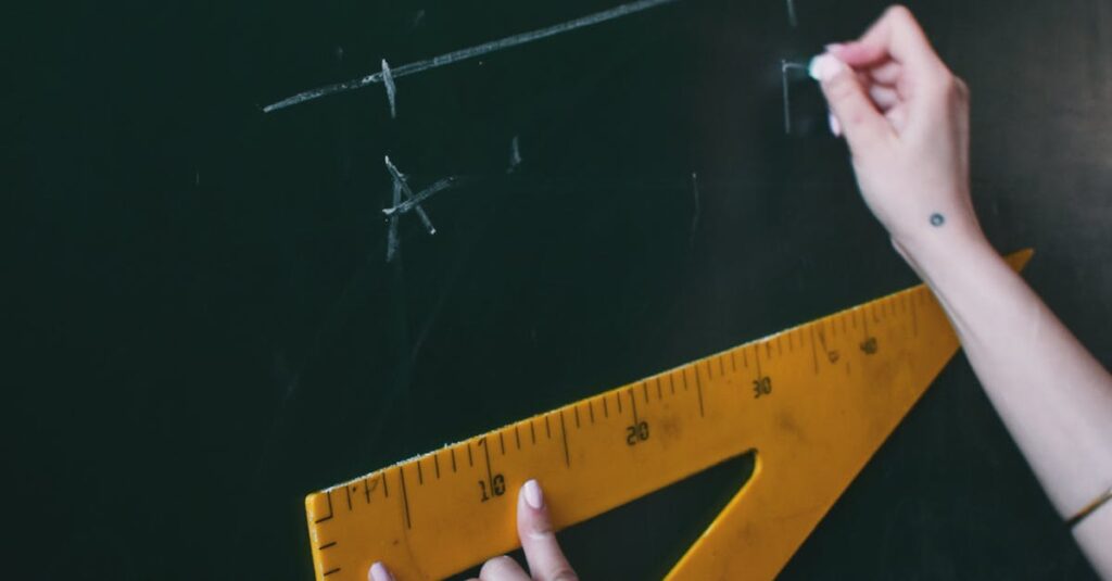 Two hands drawing a line with chalk on a blackboard using a triangle ruler